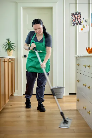 merry maid mopping the floor